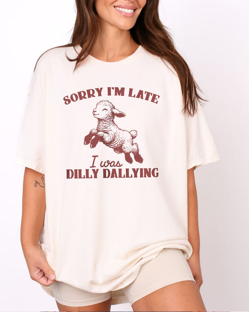 Woman wearing natural color shirt with 'Sorry I'm Late I Was Dilly Dallying' graphic design